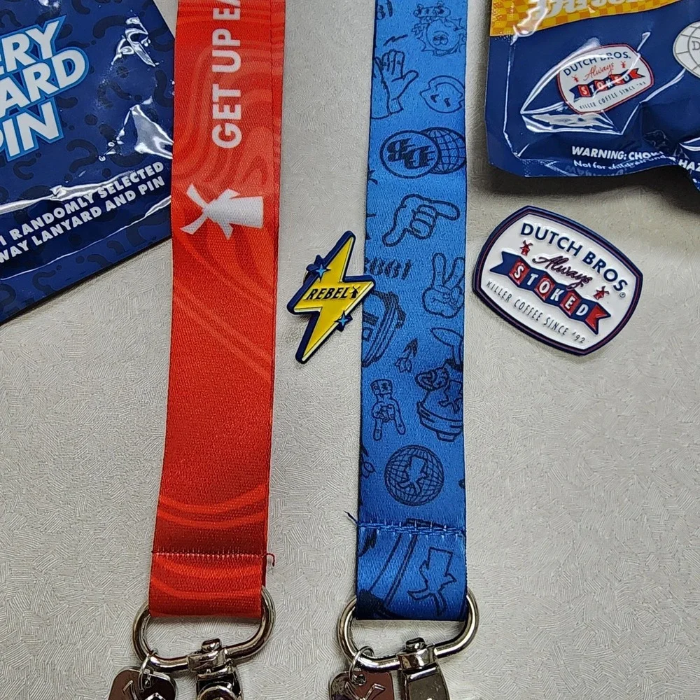 Set Of 2 Dutch Bros Pin and Lanyards 6/25/26 Red/Blue Lightning Bolt Always Stok
